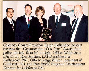 Celebrity Centre President Karen Hollander (center) receives the 'Organization of the Year' Award from police officials.